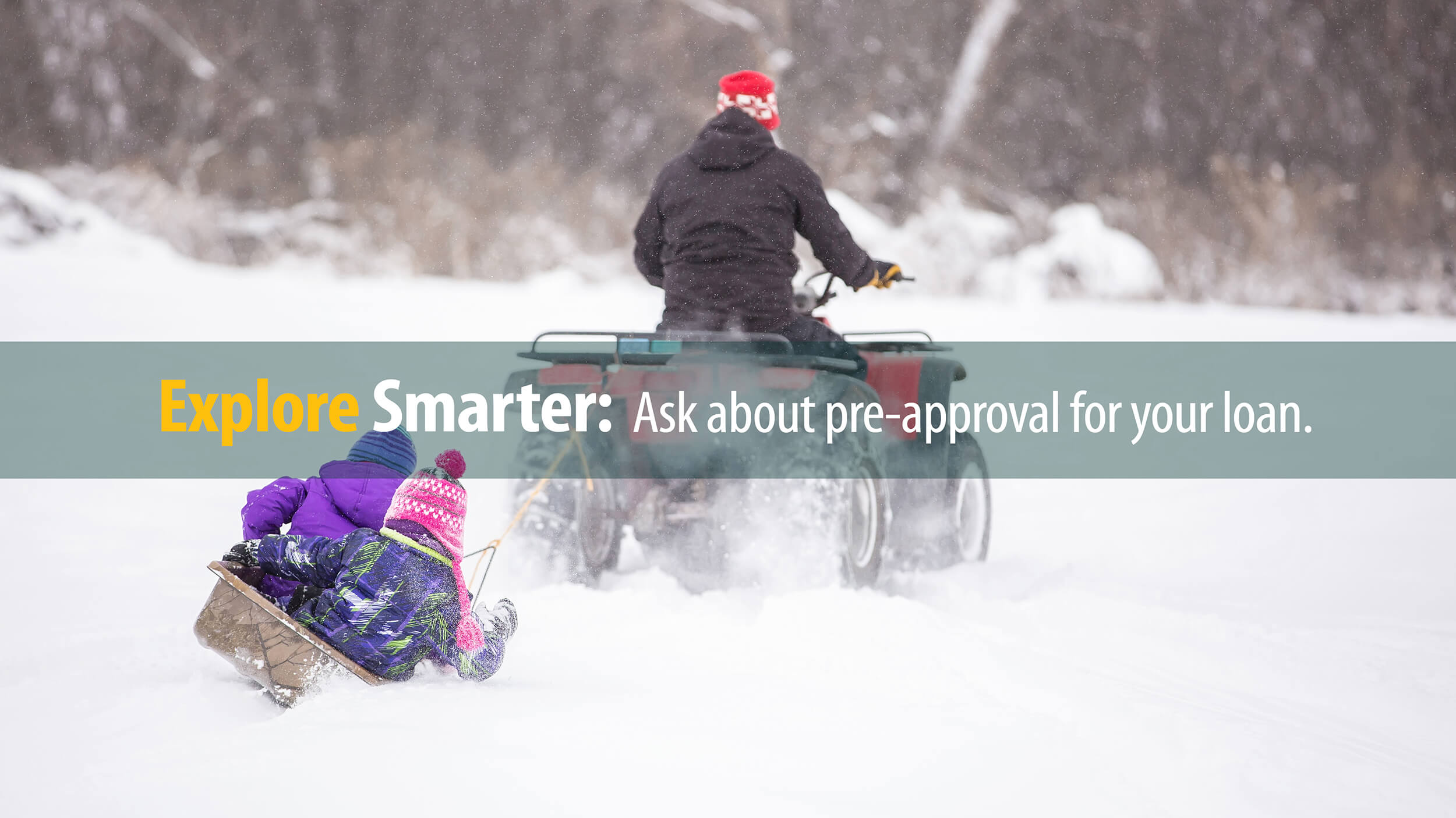 Adult on 4-wheeler purchased with First Source financing tows kids on sled through snow